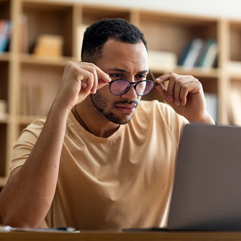 Man focusing clearly on his laptop work, an everyday moment of concentration